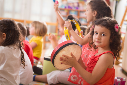 Children playing music together in a group session