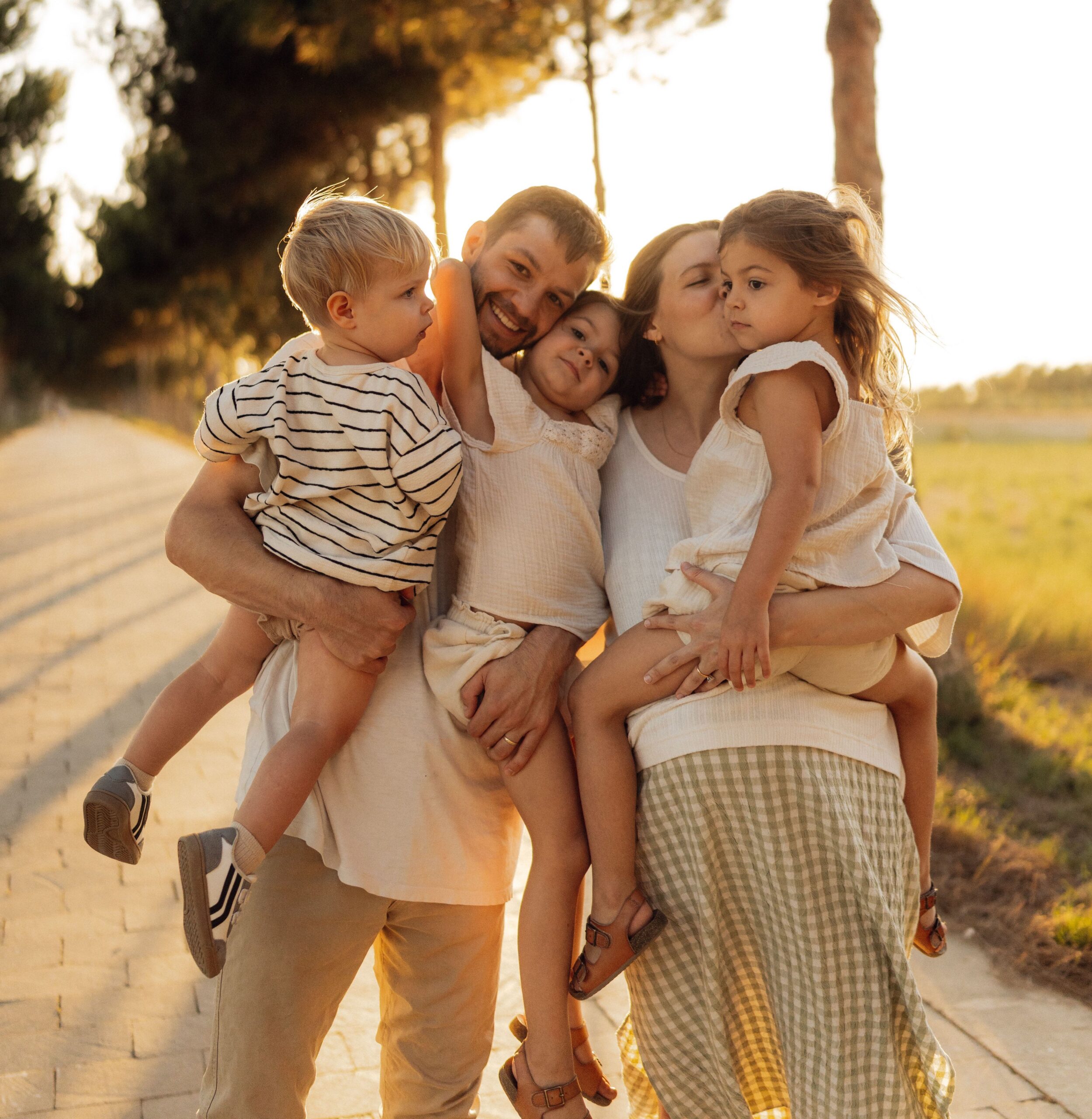 Family smiling in a park